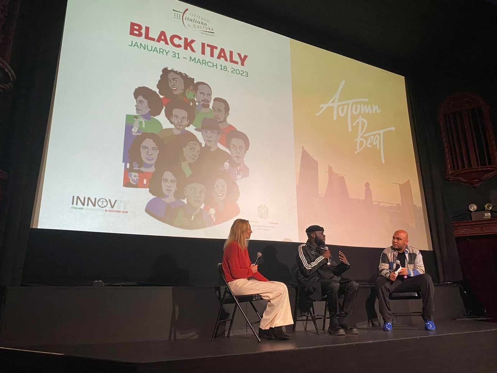 Panelists on stage speaking with powerpoint reading "Black Italy" behind them